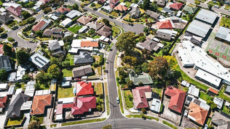 An aerial view of a leafy Melbourne suburb, with tree-lined streets and family homes.
